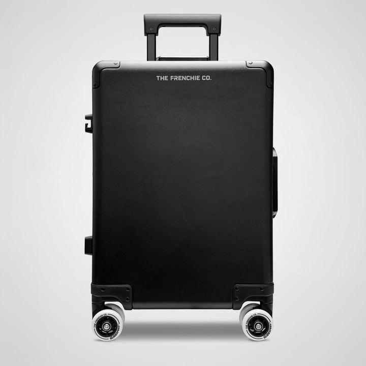 Black suitcase with 'The Frenchie Co.' branding on a light gray background