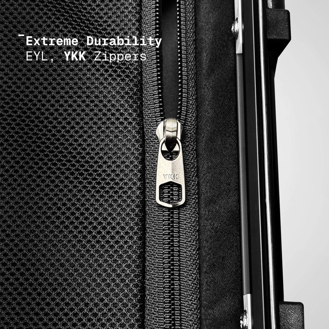 Close-up of a black suitcase with a YKK zipper, emphasizing durability.
