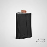 Black leather wallet with a brown pull tab on a light gray background, featuring a '5 Year Warranty' text.