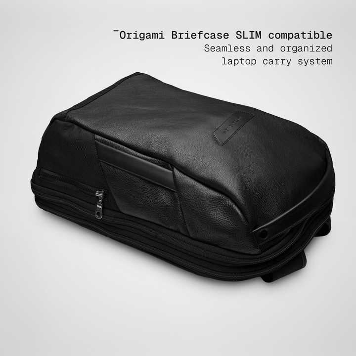 Slim briefcase sliding into the black leather Vector Speed Backpack