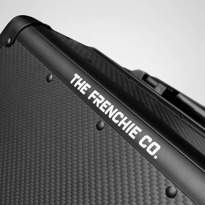 Black briefcase case with 'The Frenchie Co.' branding on a gray background