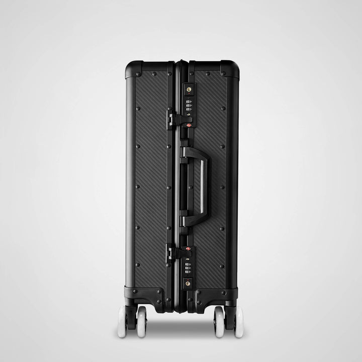 Black suitcase with a geometric pattern on a light gray background