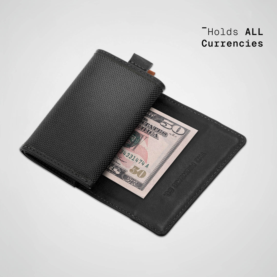 Black wallet with a $50 bill inside on a light gray background