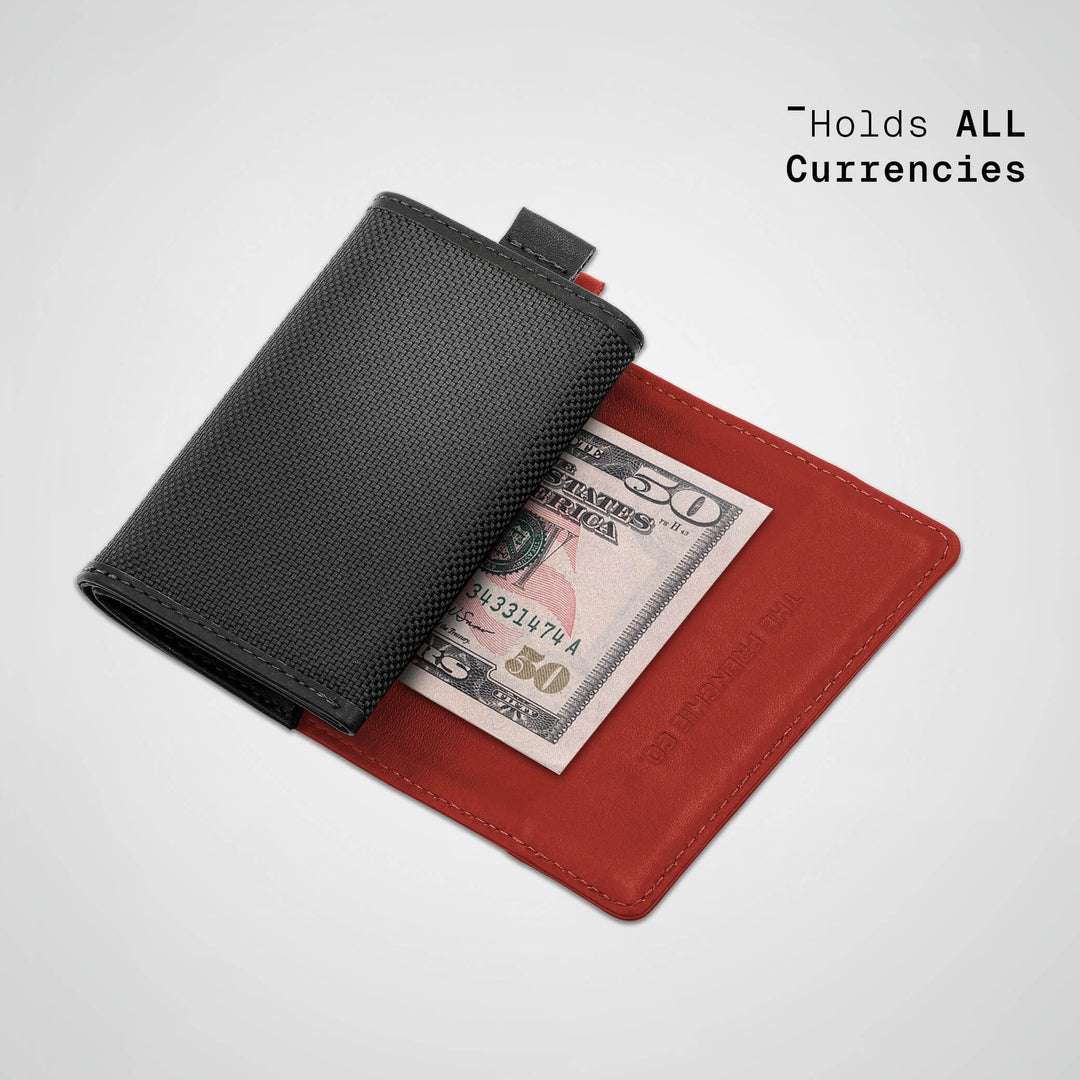Black and red wallet with a dollar bill on a light gray background
