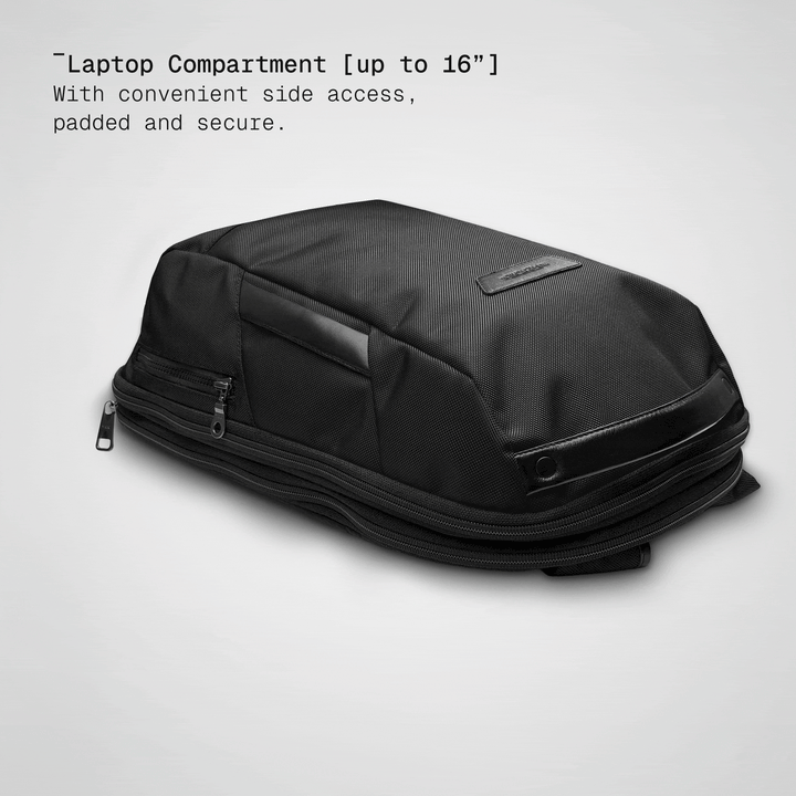 Laptop sliding into the padded compartment of the black Vector Speed Backpack
