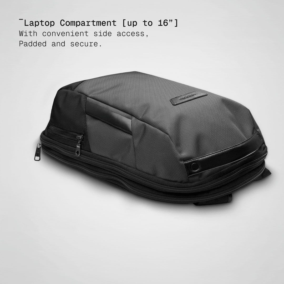 Laptop sliding into the padded compartment of the grey Vector Speed Backpack