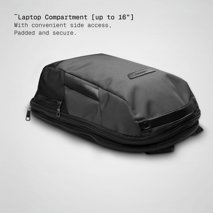 Laptop sliding into the padded compartment of the grey Vector Speed Backpack