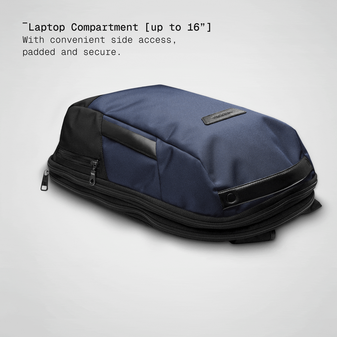 Laptop sliding into the padded compartment of the ultra navy Vector Speed Backpack