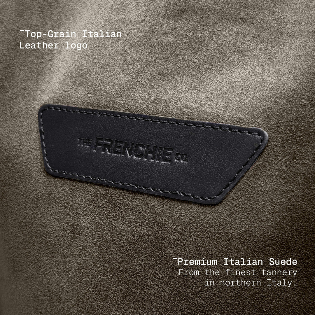 Embossed leather logo patch on taupe suede