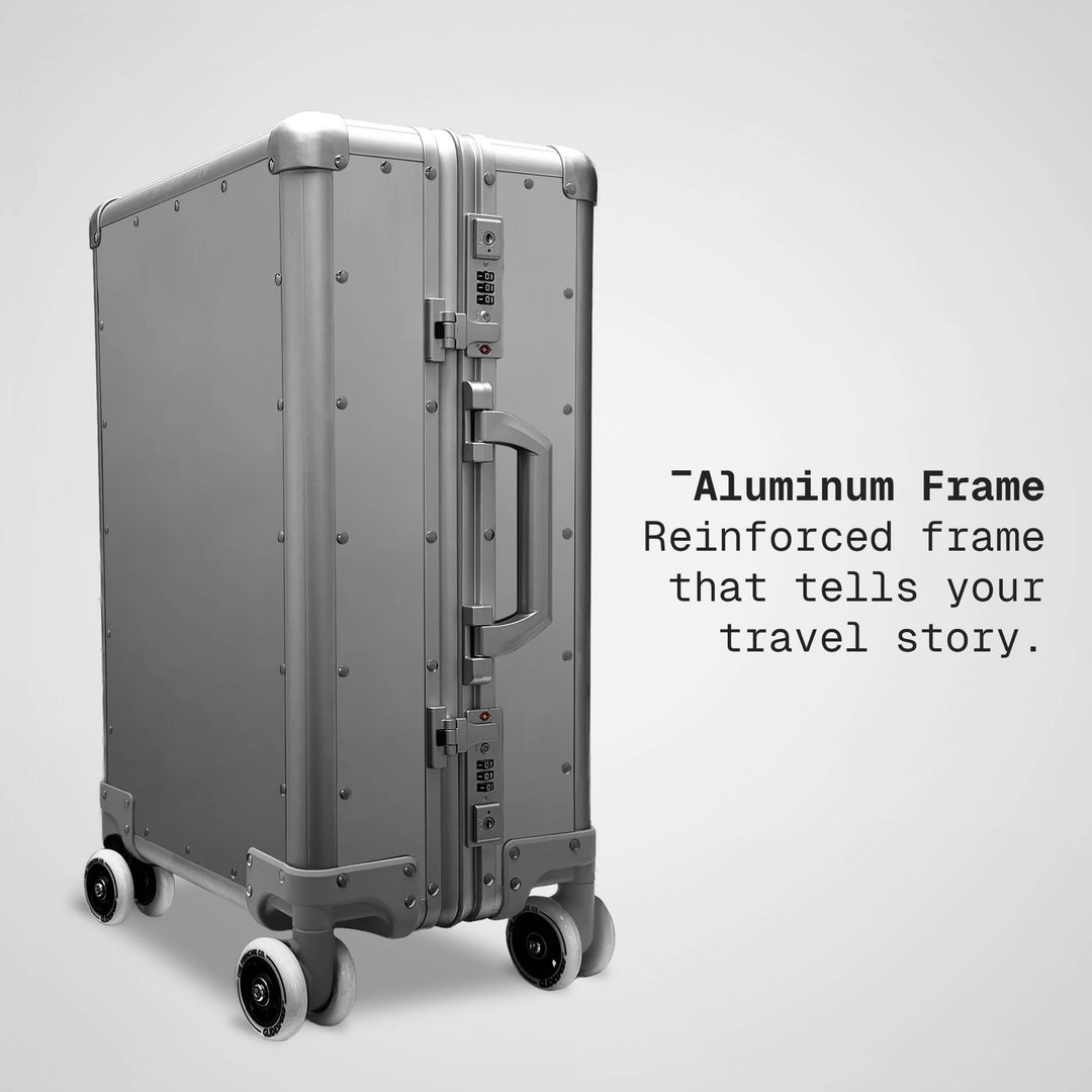 Silver suitcase with text about an aluminum frame on a light gray background
