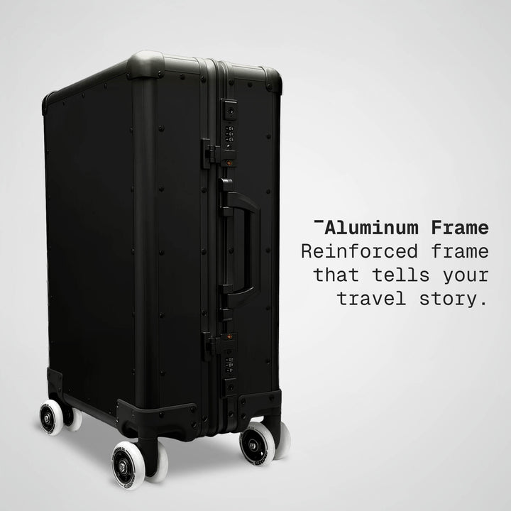 Black suitcase with text about an aluminum frame on a light gray background