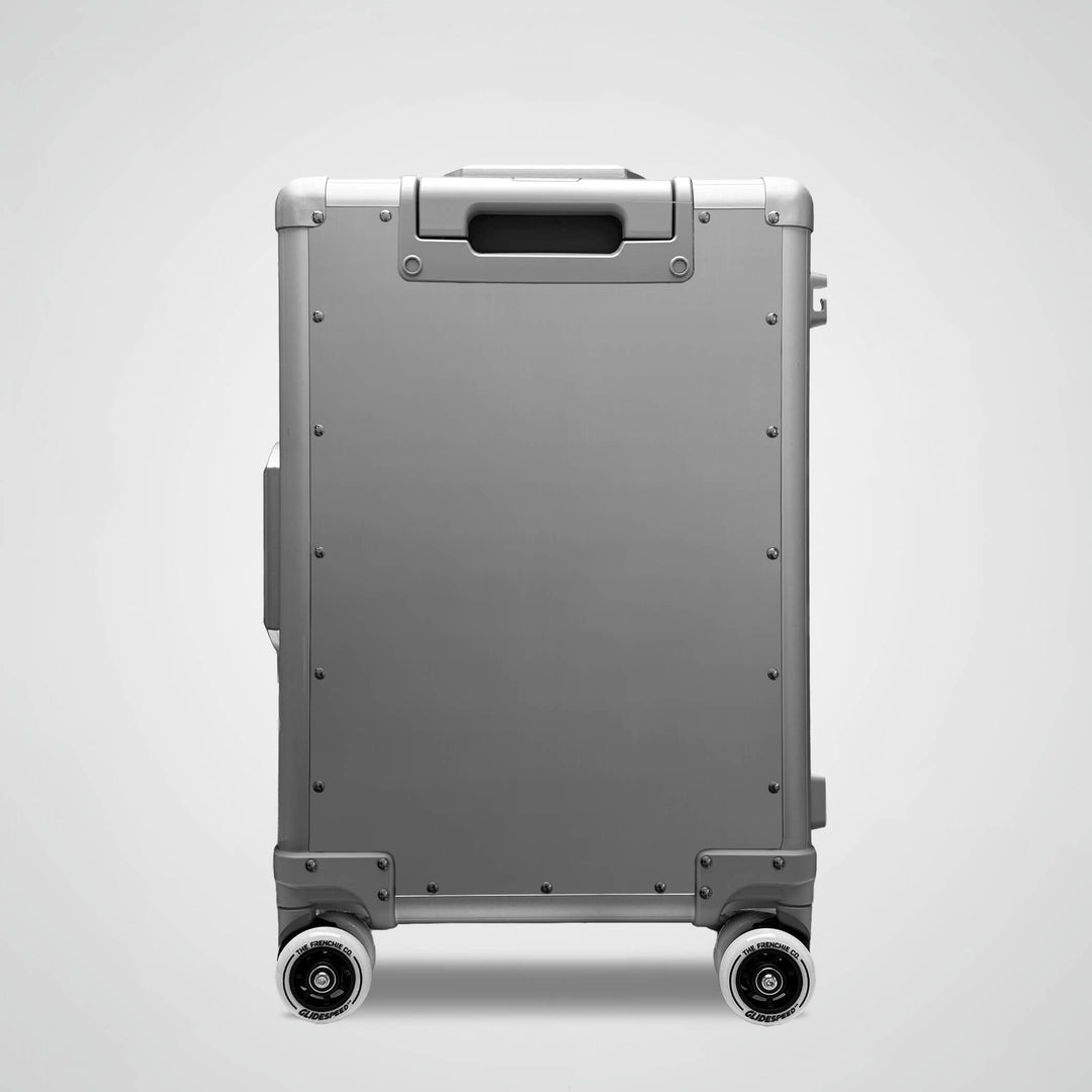 Gray suitcase with wheels on a light gray background