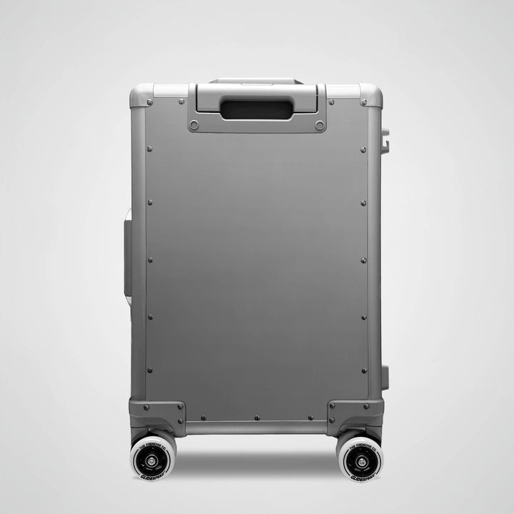 Gray suitcase with wheels on a light gray background