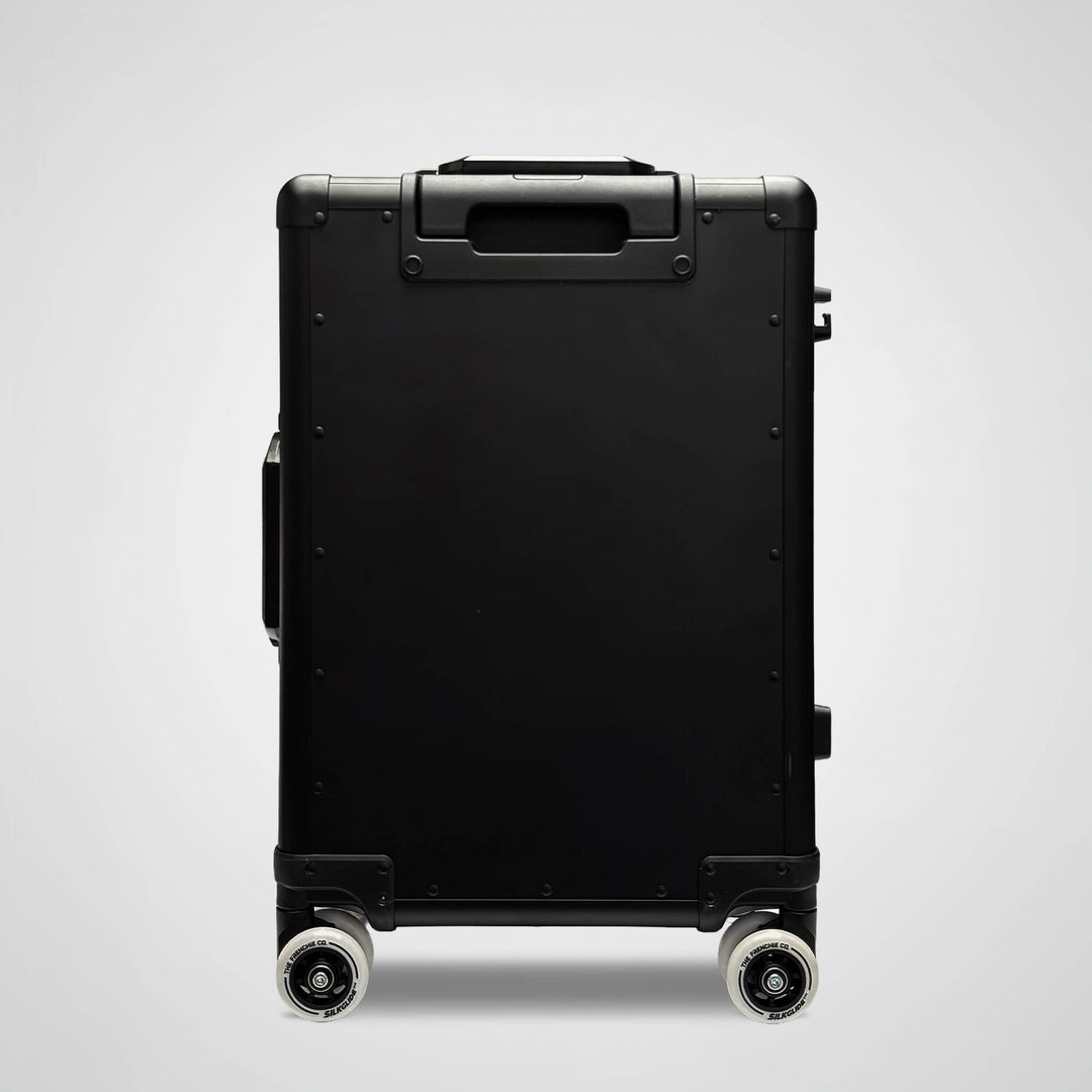 Black suitcase with wheels on a light gray background