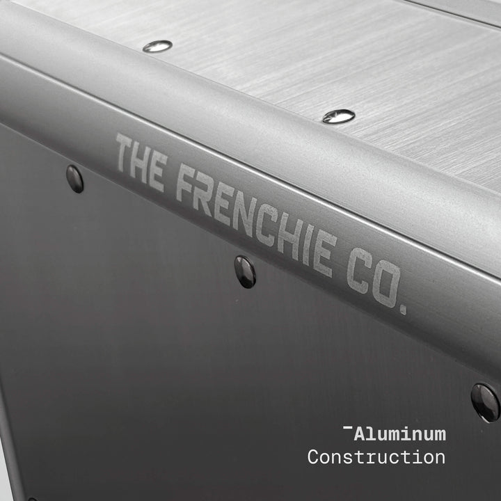 Metallic surface with 'The Frenchie Co.' branding and 'Aluminum Construction' text.