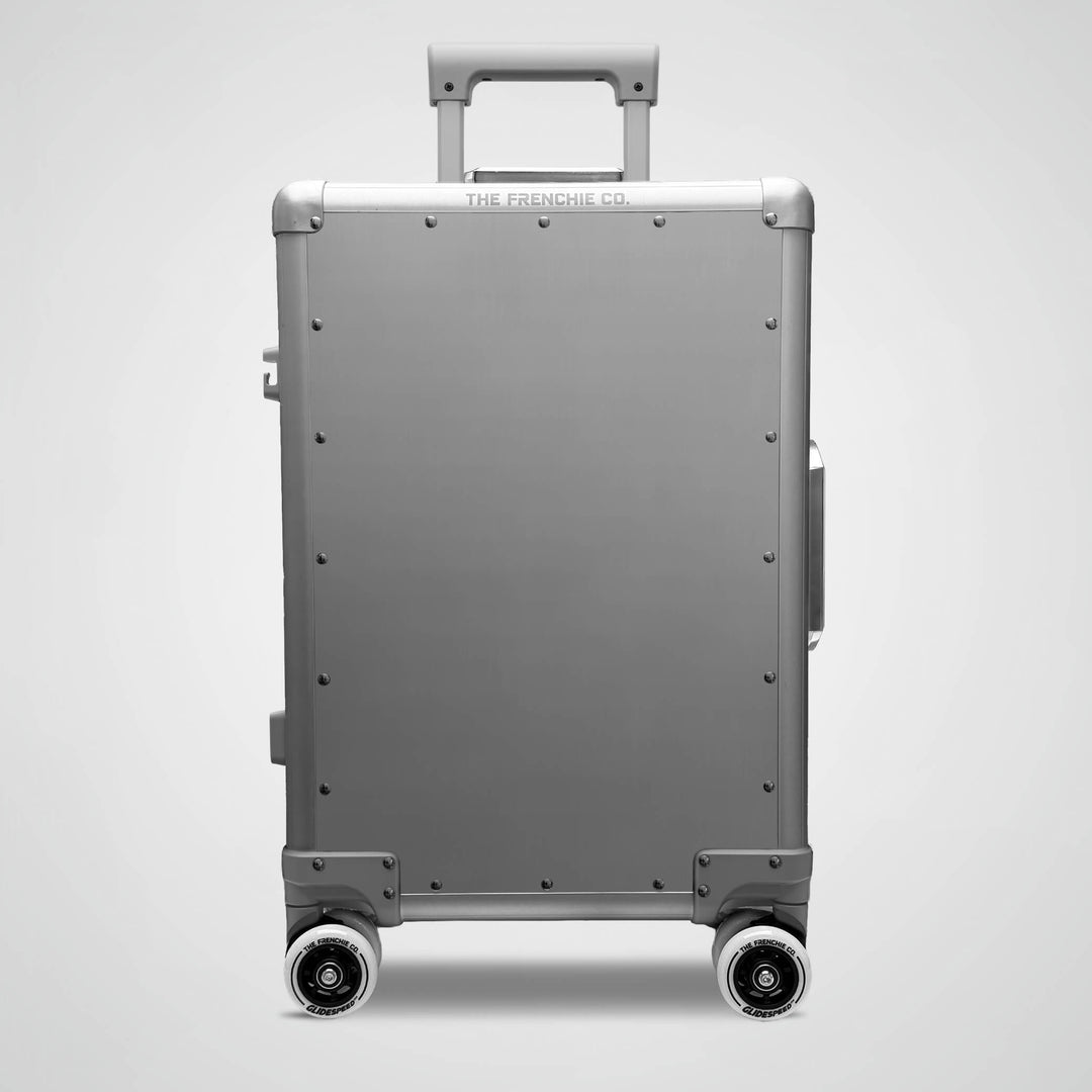 Gray suitcase with wheels on a light gray background