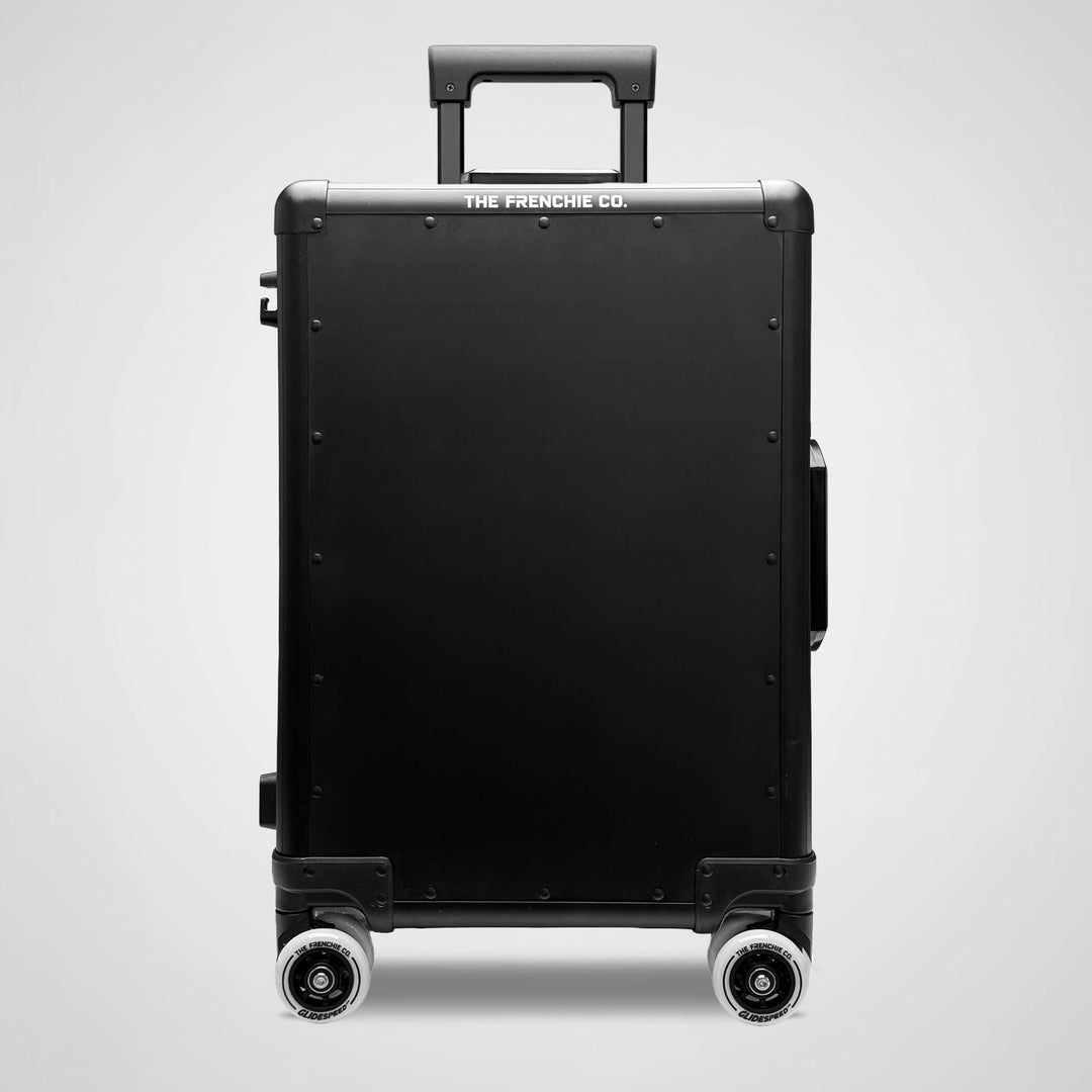 Black suitcase with 'The Frenchie Co.' branding on a light gray background
