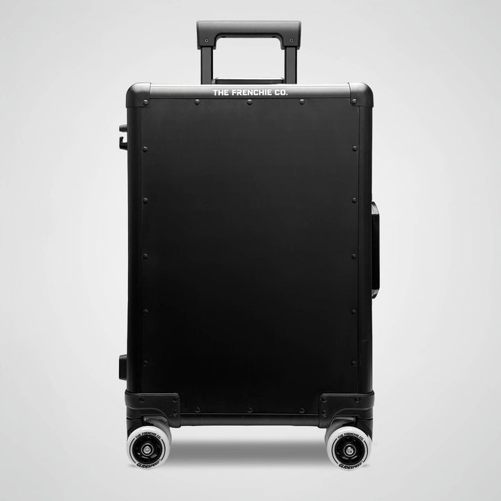 Black suitcase with 'The Frenchie Co.' branding on a light gray background