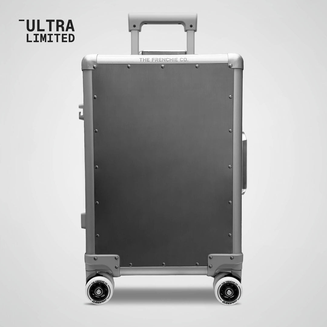 Gray suitcase with wheels on a light gray background