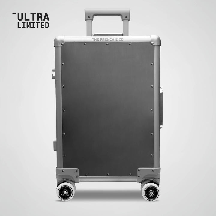 Gray suitcase with wheels on a light gray background