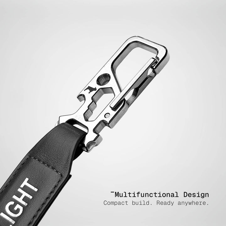 Multifunctional keychain with carabiner and leather strap on a light gray background