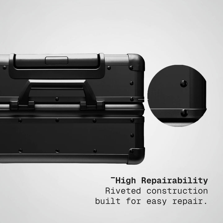 Black toolbox with riveted construction feature on a gray background