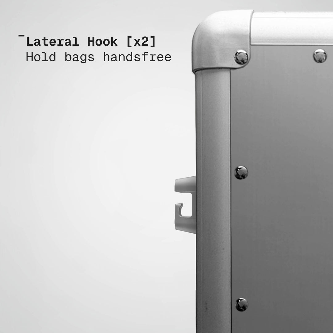 Metallic suitcase with lateral hooks on a white background
