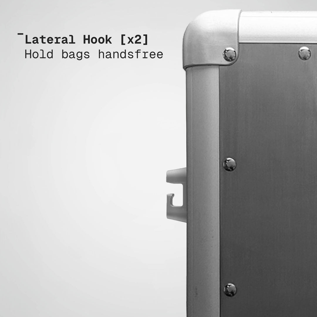 Metallic suitcase with lateral hooks on a white background
