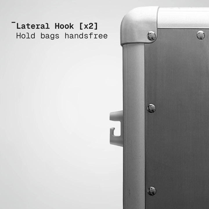 Metallic suitcase with lateral hooks on a white background