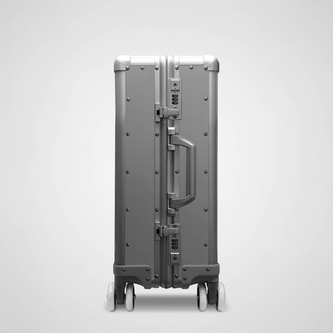 Gray suitcase with a handle on a light gray background