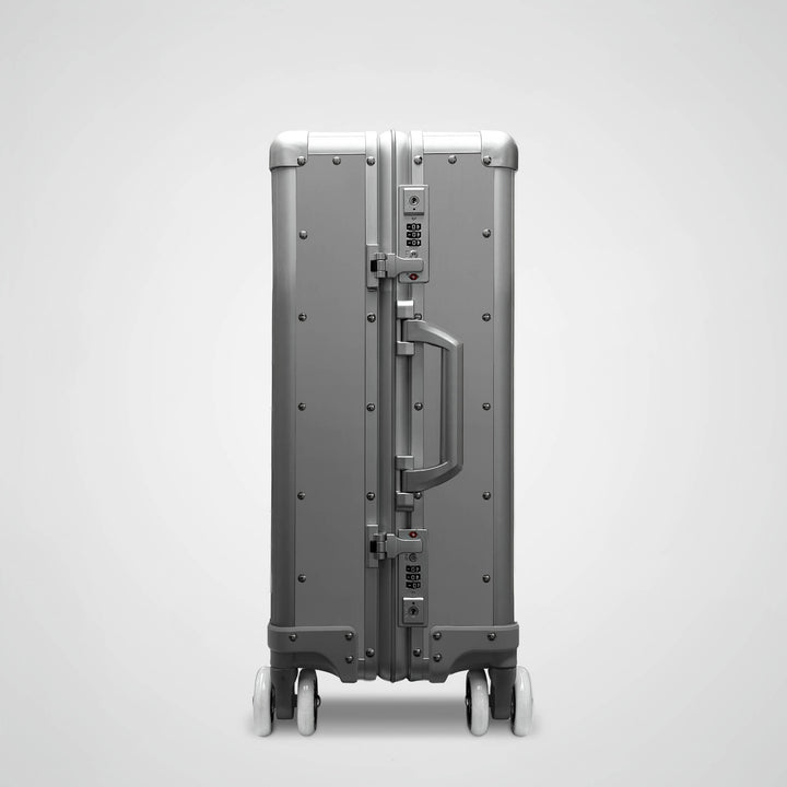 Gray suitcase with a handle on a light gray background