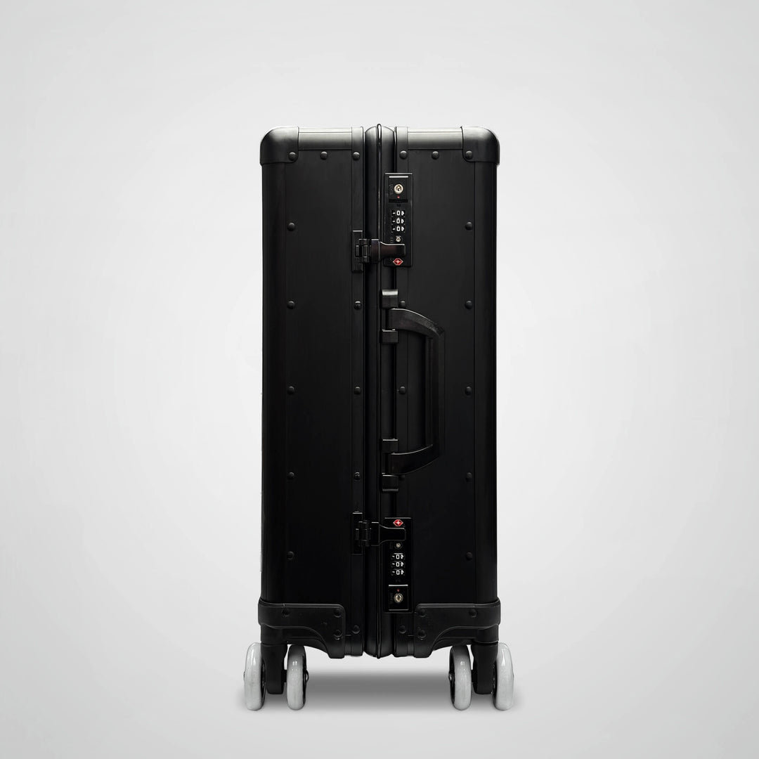 Black suitcase with wheels on a light gray background