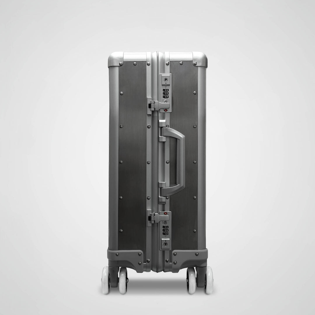 Silver suitcase with a unique design on a light gray background