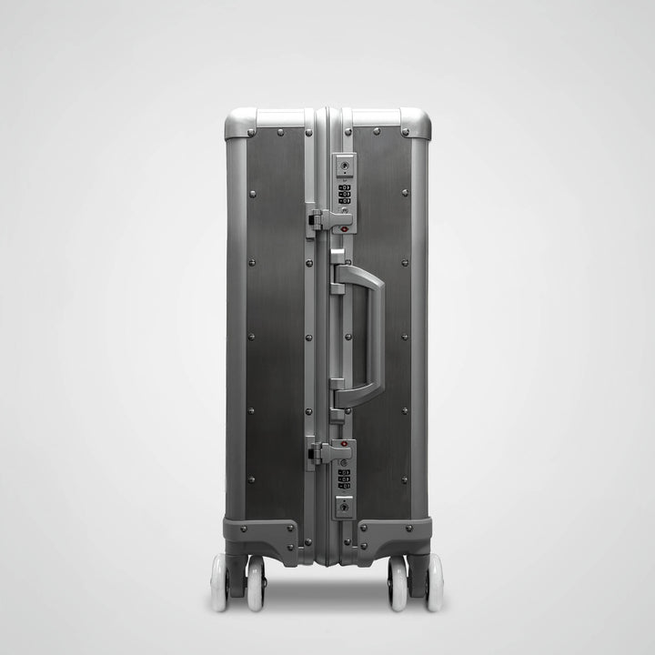 Silver suitcase with a unique design on a light gray background