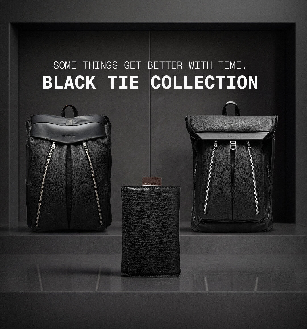 Black leather bags with 'Black Tie Collection' text on a dark background