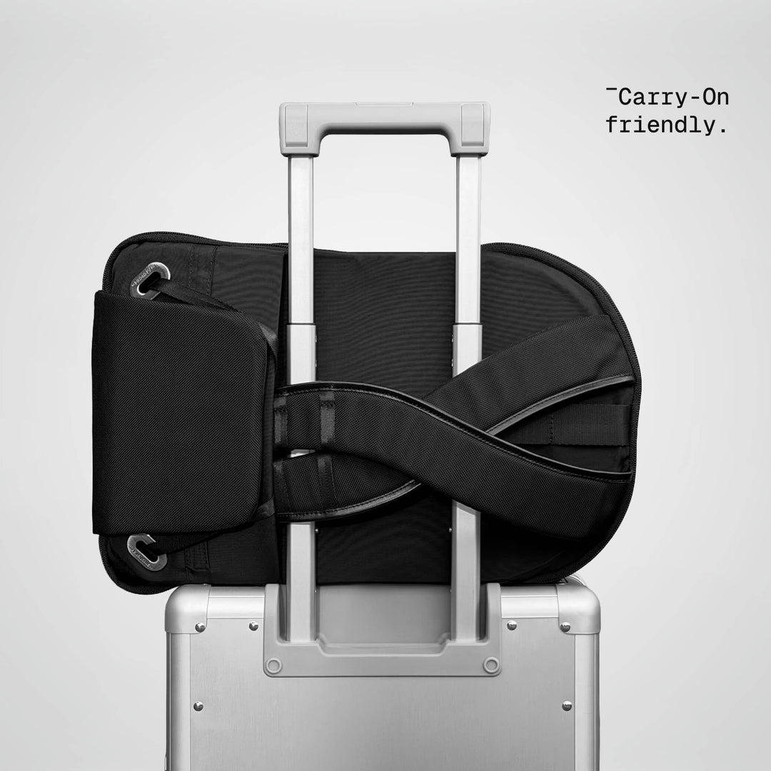 Speed Backpack resting on a carry-on luggage handle