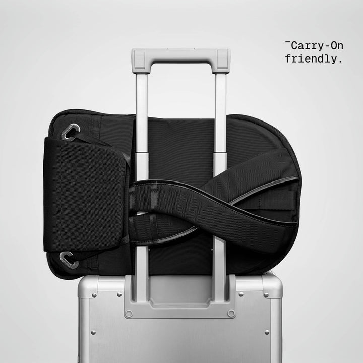 Speed Backpack resting on a carry-on luggage handle