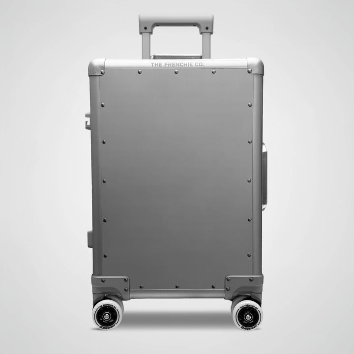 Aluminum suitcase with wheels on a light gray background