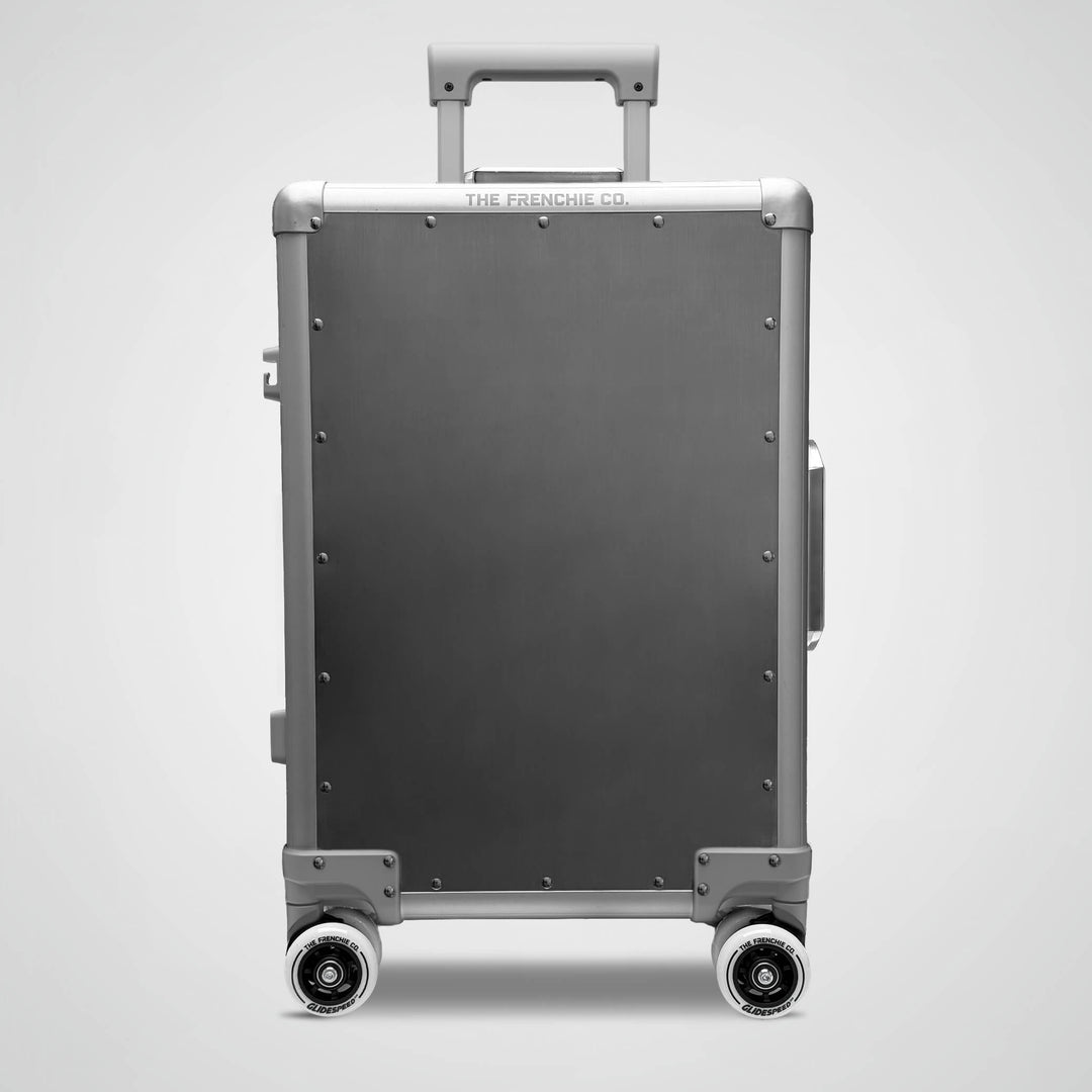 titanium suitcase with wheels on a light gray background